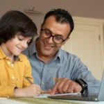 Father guiding child in an online Montessori course.