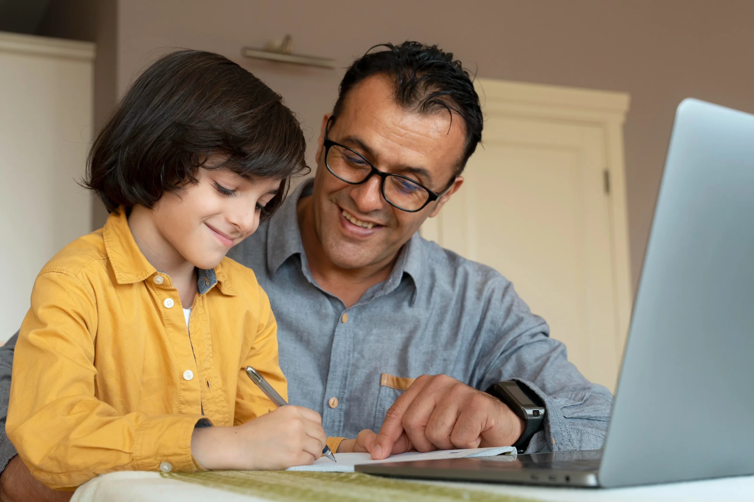 Father guiding child in an online Montessori course.