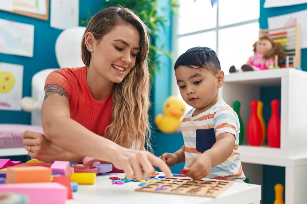 Pre-primary teaching activity with a child solving a puzzle