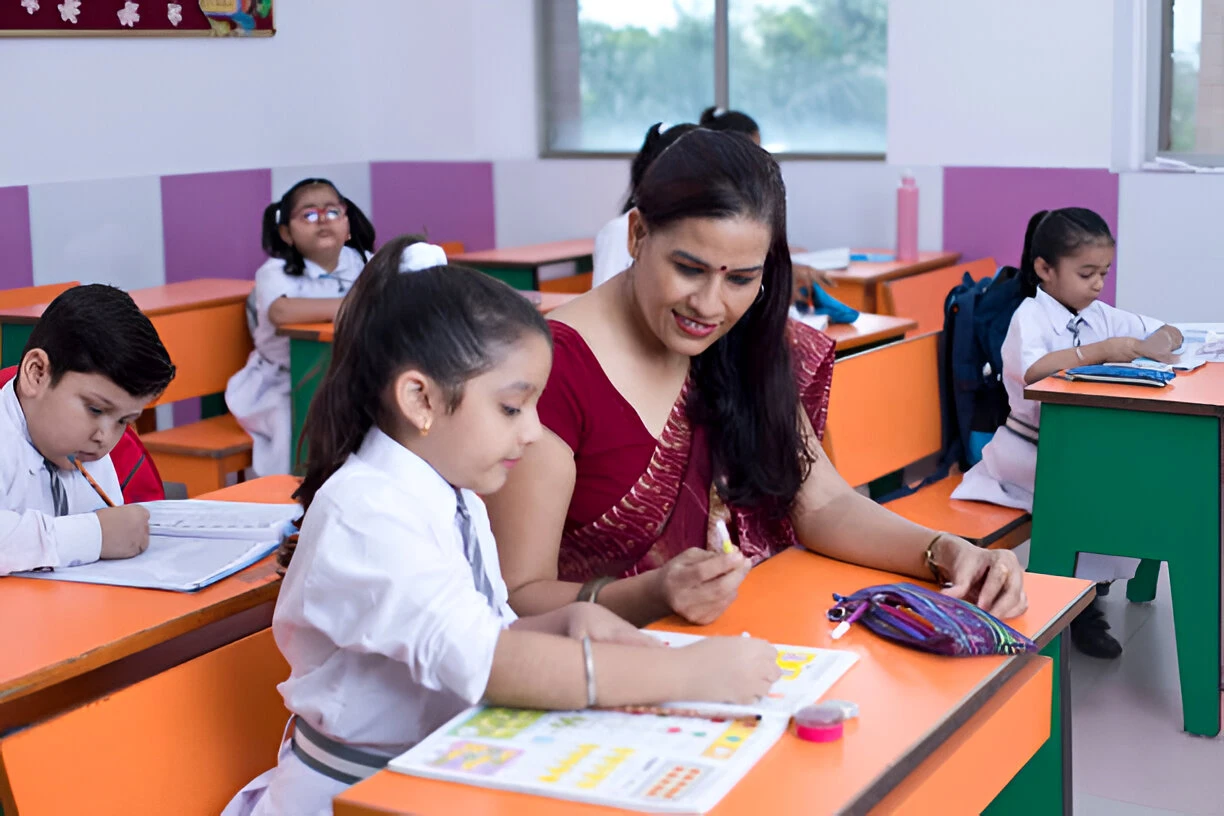 Preschool teacher training classroom with teacher guiding a young student