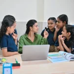 Teacher interacting with young students during phonics training for teachers.