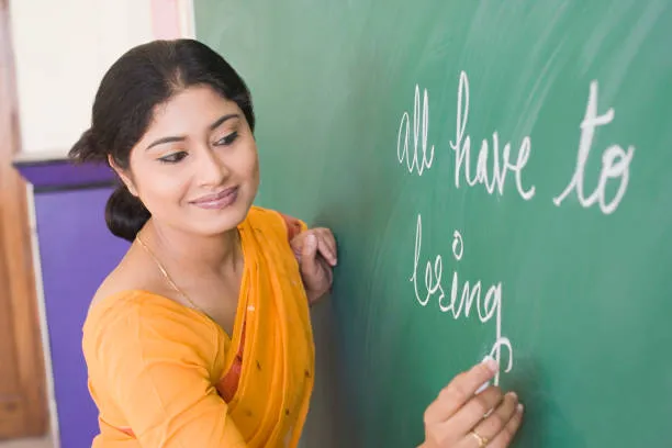 Teacher writing on board during teacher training course session.