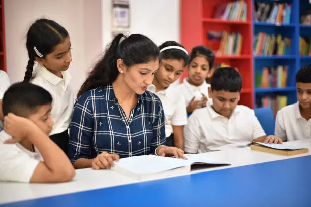 hadow teacher supporting child in classroom