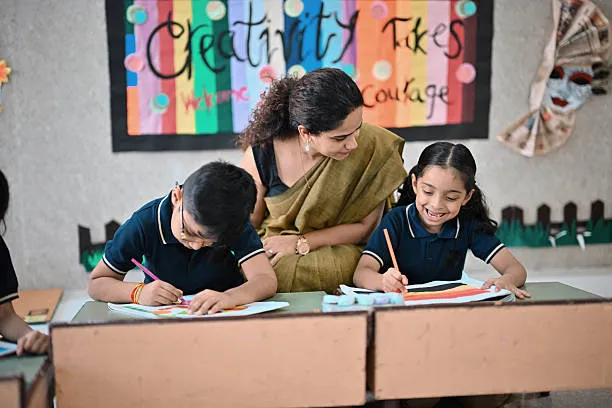 Special education classroom activity with teacher guiding children during drawing task