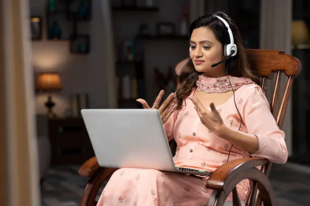 Woman attending online counselling course in India via laptop session.