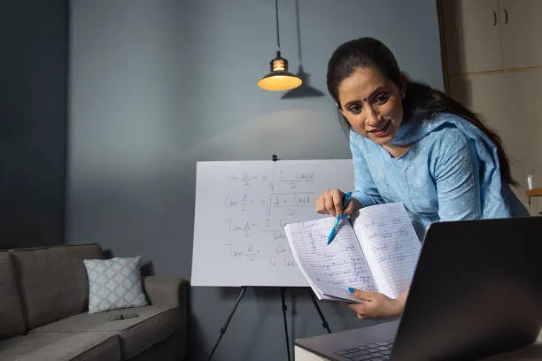 Woman attending online teacher training courses while studying educational notes during a virtual learning session.