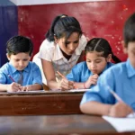 Teacher assisting children during classroom activities as part of a diploma in special education program.