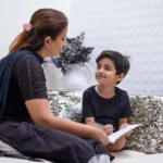 Educator guiding a child during a child psychology session
