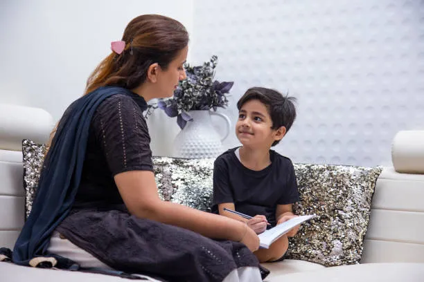 Educator guiding a child during a child psychology session