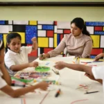 teacher in a phonics training set up
